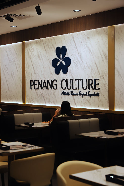 Restaurant interior with 'Penang Culture' logo on the wall